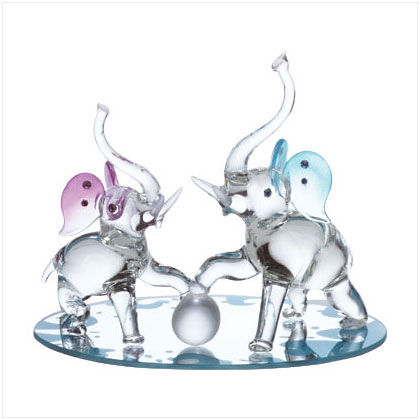 Two playful elephants on a mirror base